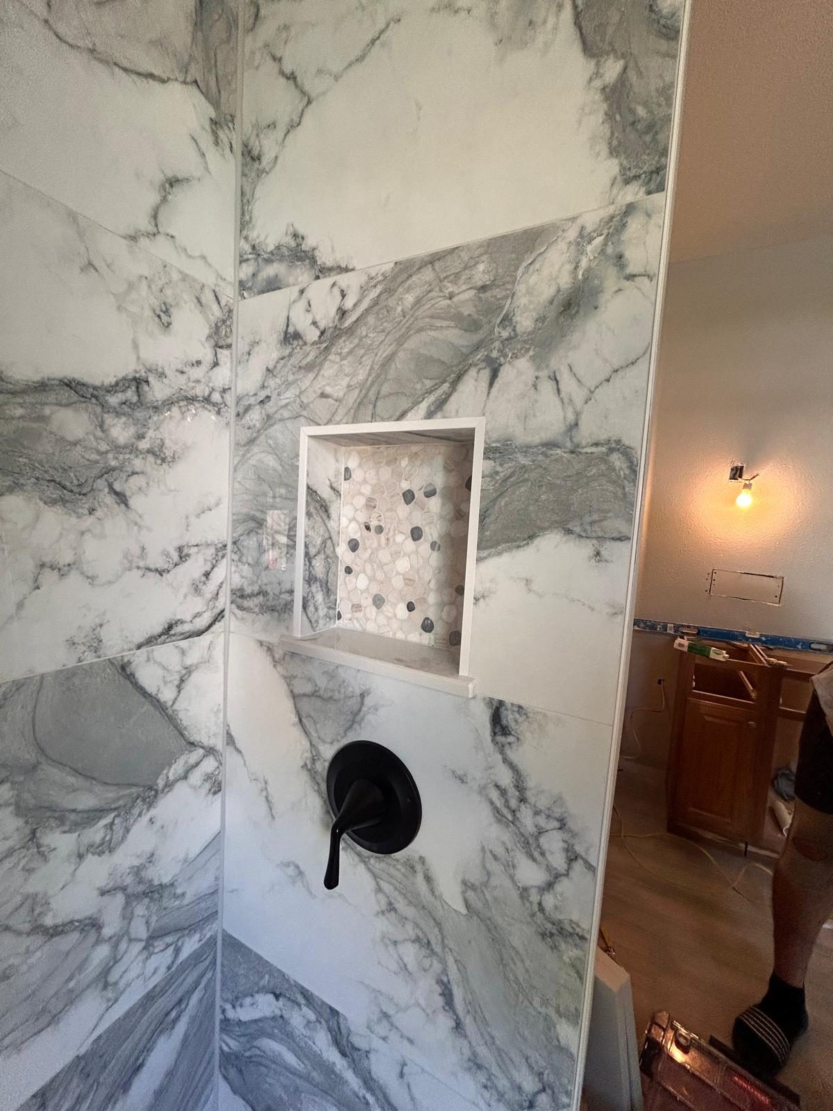 Dramatic book-matched stone shower